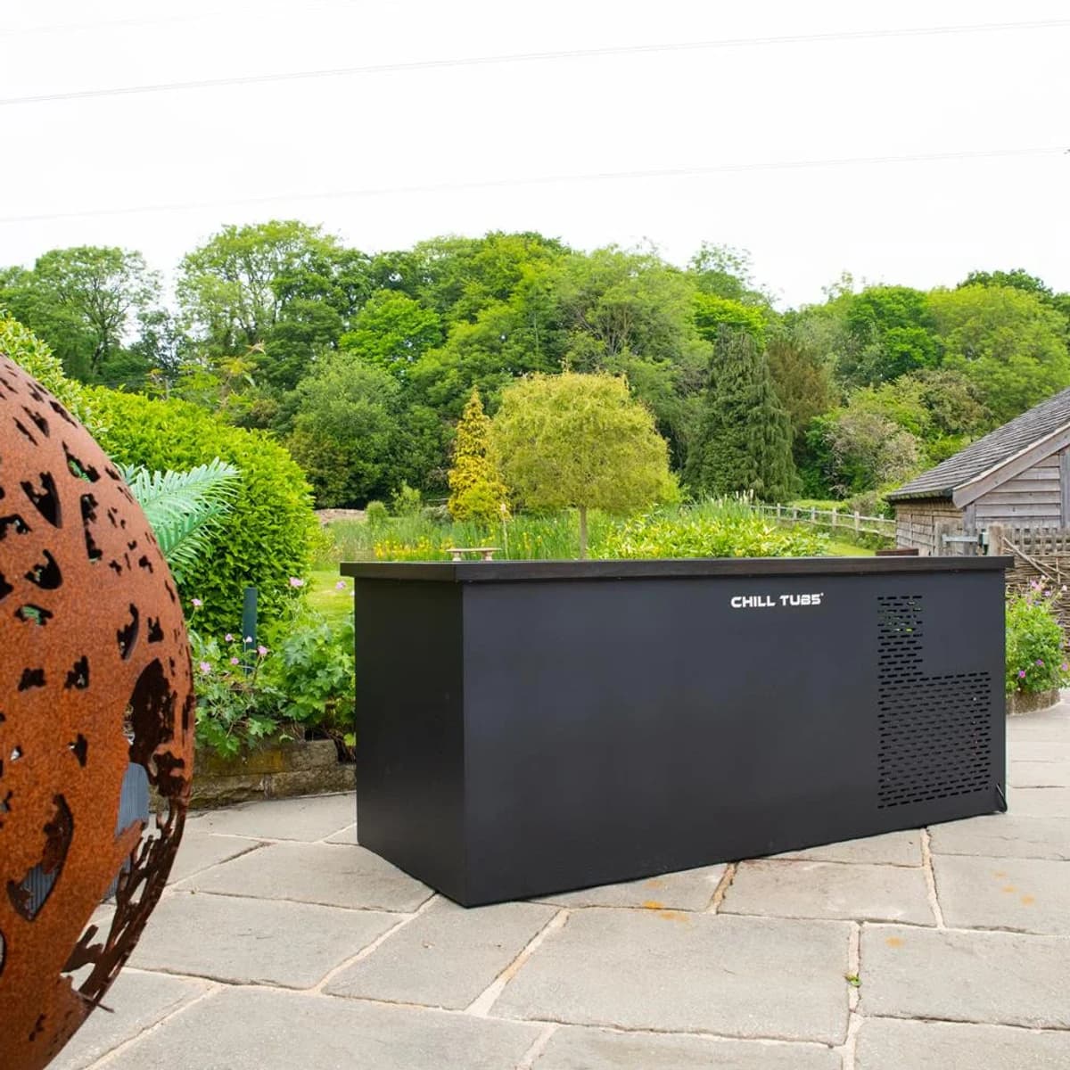 Full Chill Tubs Original cold plunge placed on an outdoor stone patio