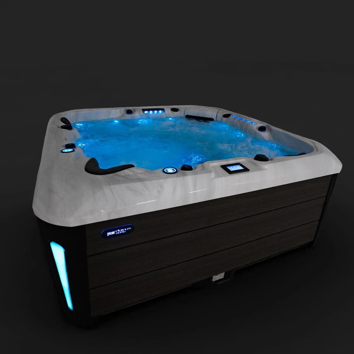 Platinum Spas Barcelona hot tub with blue-lit water at night, three-quarter view