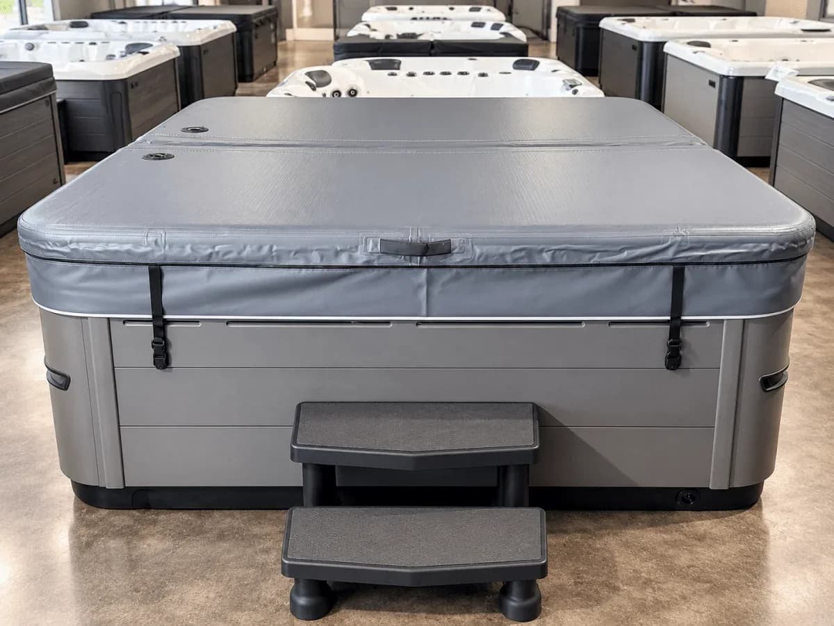 Aircap manufacturer product photo showing a fitted square spa cover in a showroom