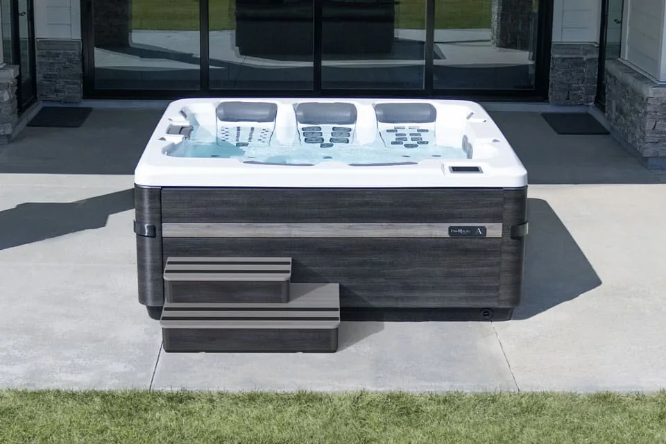 Bullfrog hot tub with steps and room around the cabinet on a patio
