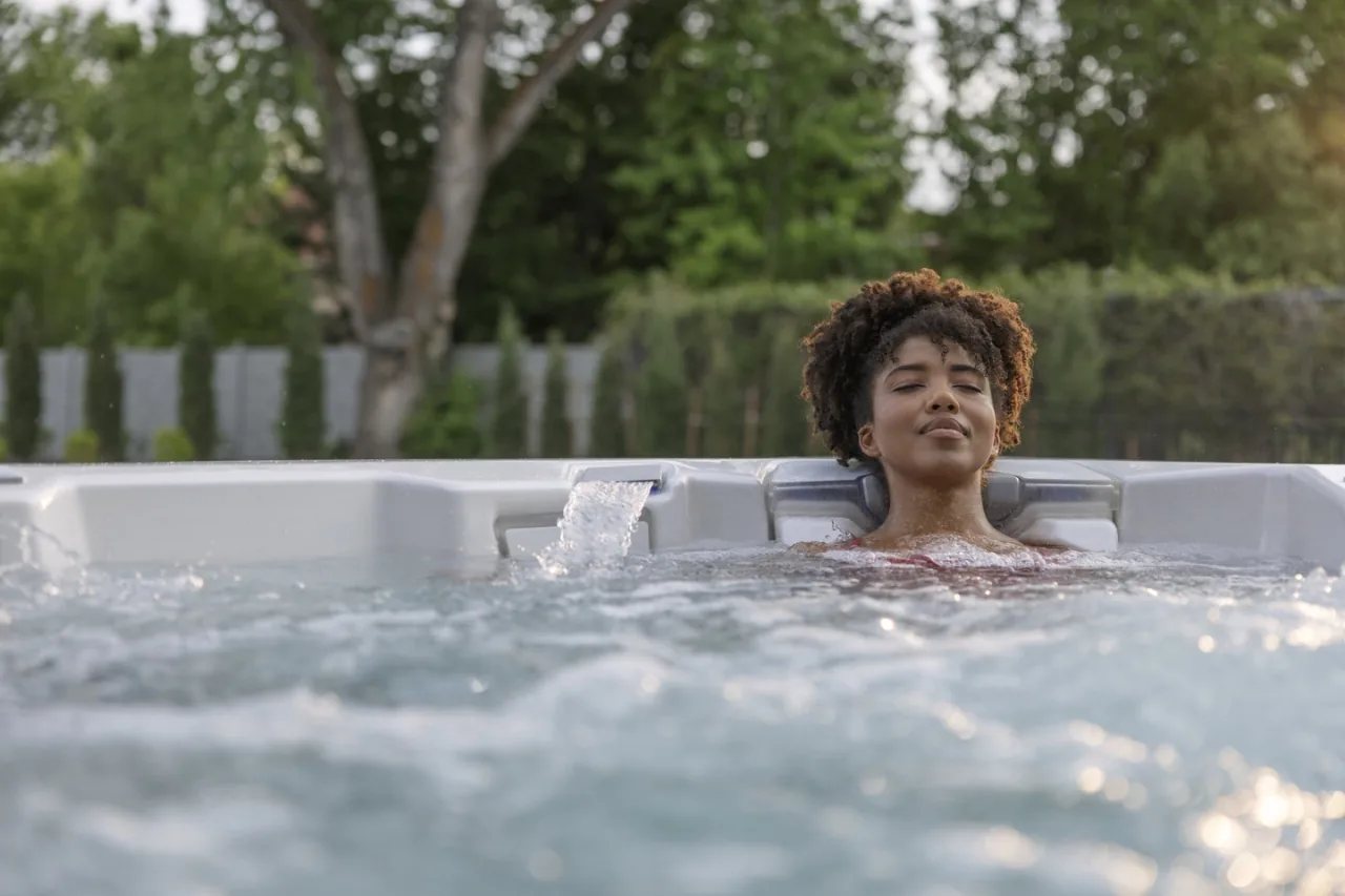 Spa owner relaxing beside the waterline in a Bullfrog hot tub