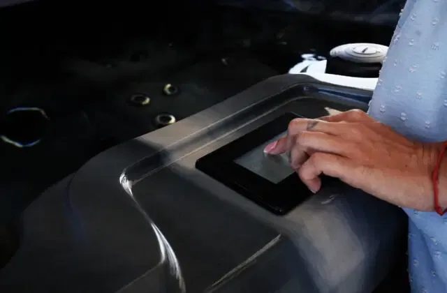 Hand selecting a setting on a Platinum Spas touchscreen