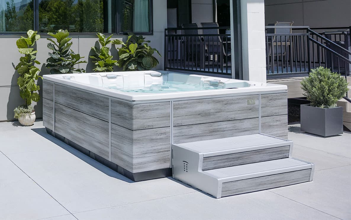 Bullfrog M Series hot tub with steps on a patio