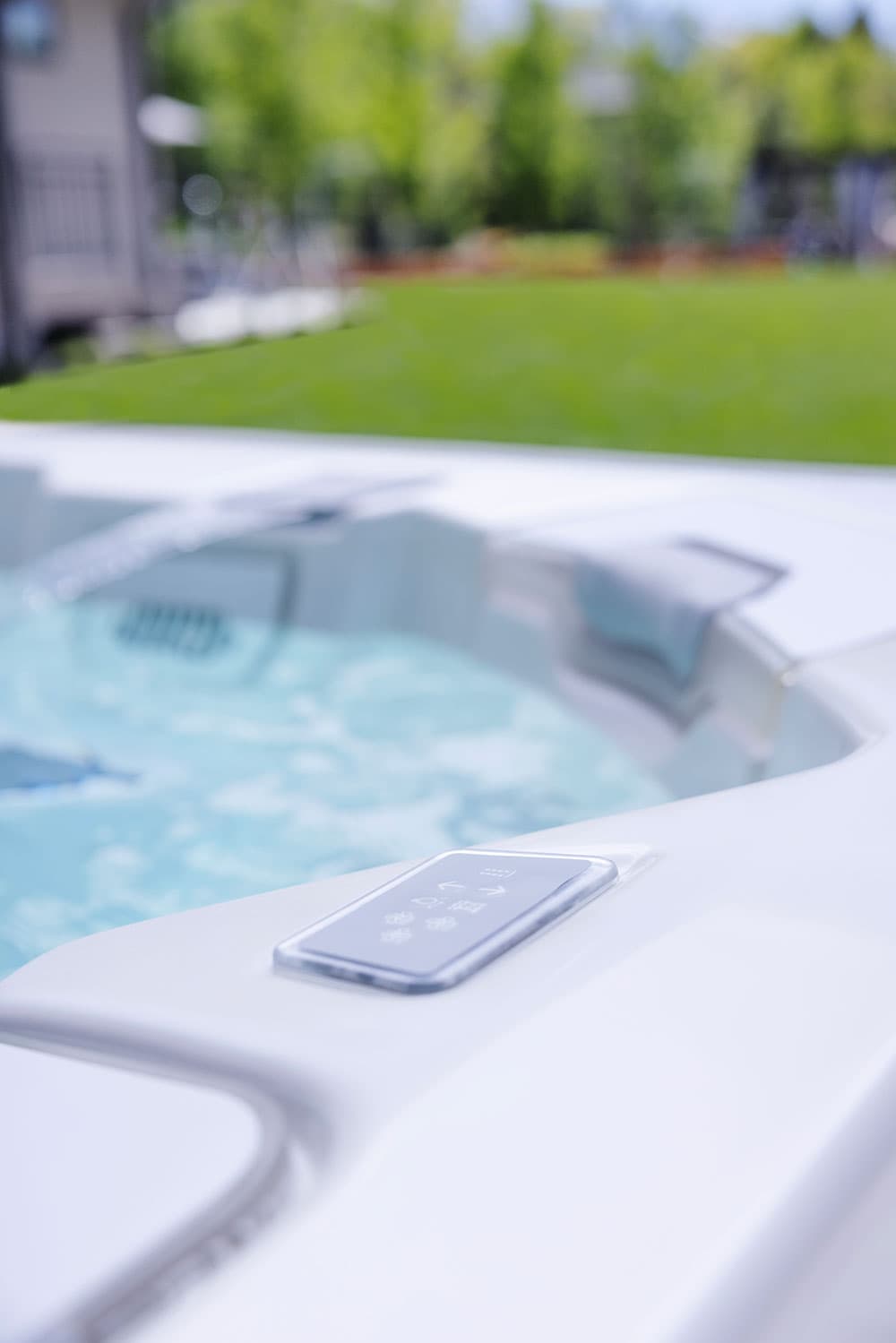 Small spa-side control on the edge of the shell
