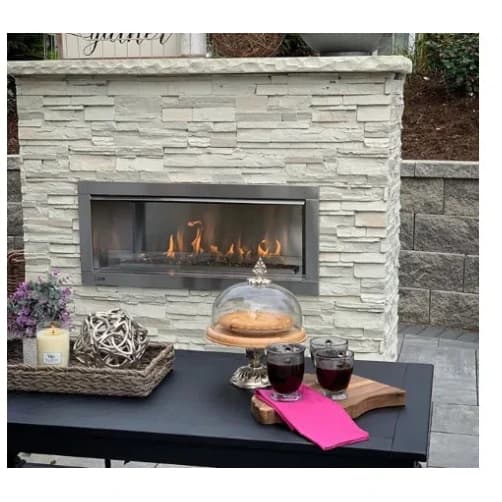 TRU Innovative Outdoor fireplace installed in a stone patio wall