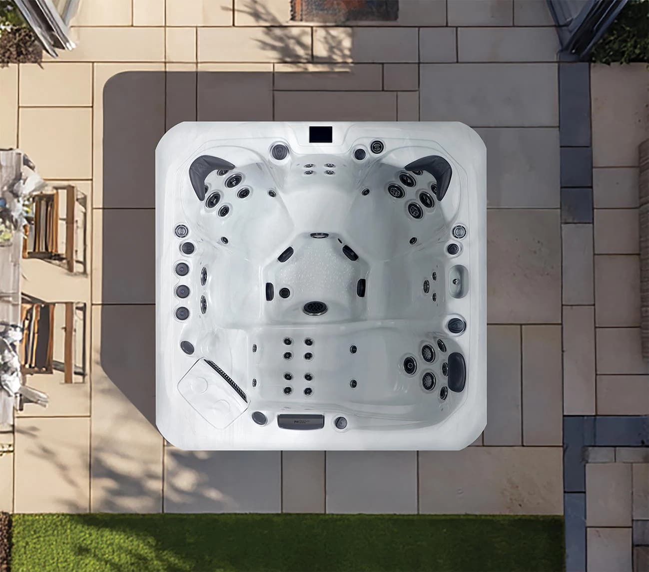 Platinum Santorini hot tub viewed from above on a patio, showing its lounge position and jet arrangement