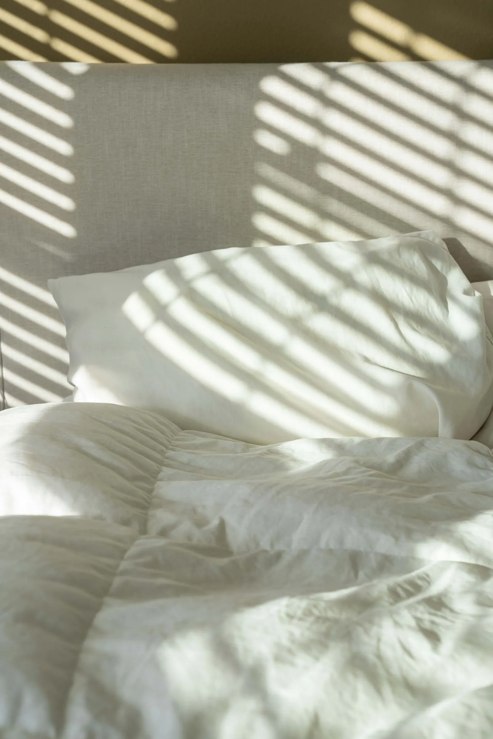 Soft white bedding in morning light