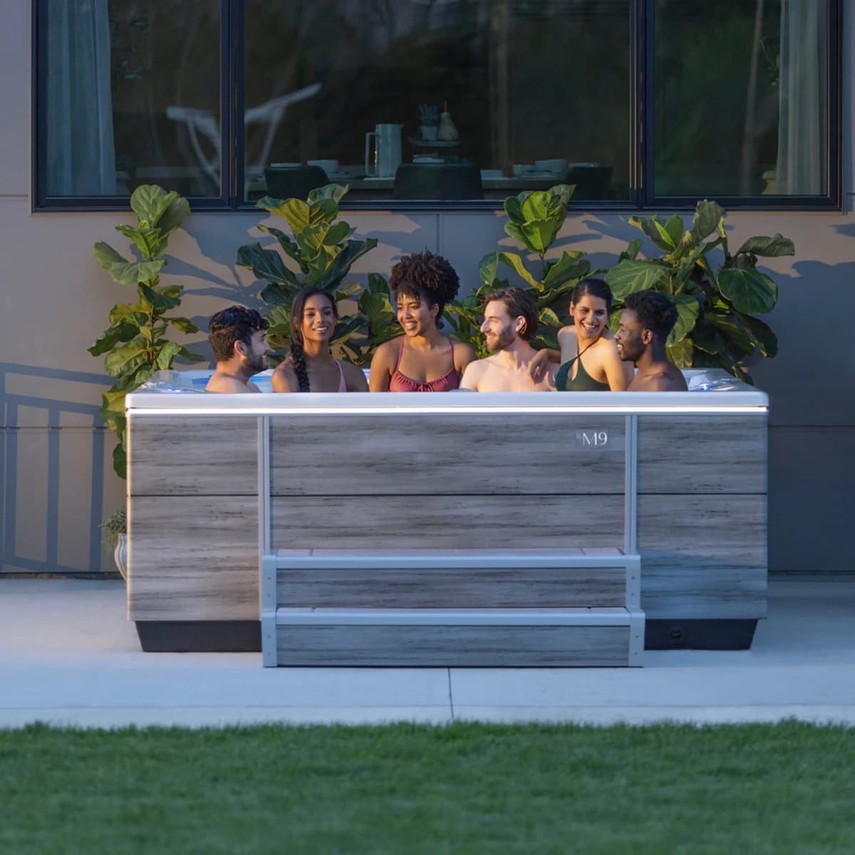 Friends relaxing in a Bullfrog Spas M9 hot tub