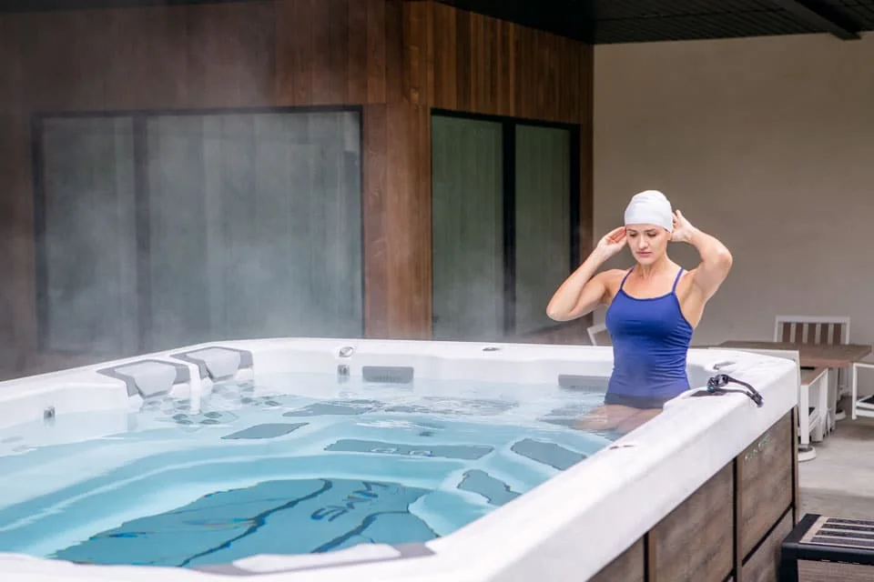 Person preparing to swim in a Bullfrog Spas Swim Series model