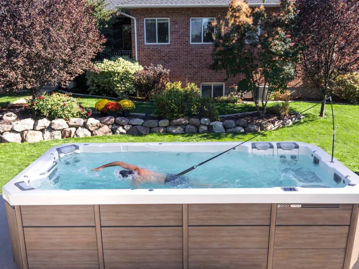 Swimmer training against the current in a Bullfrog Swim Series spa at home